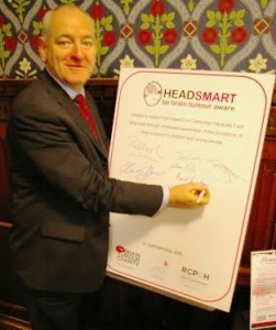 Foyle MP Mark Durkan signing the HeadSmart campaign pledge at Westminster.