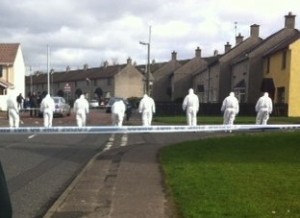 Forensic teams examining the scene of one of the bomb attacks on Romanian families in Derry in March.