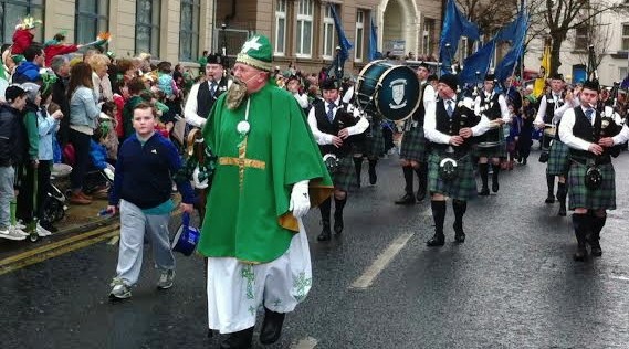 St Patrick leading the Colmcille Pipe Band along Strand Road during 2014 celebrations