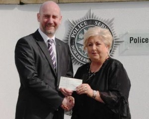 Detective Chief Inspector Mark McClarence presenting a cheque for £5,480 to Sadie O’Reilly of HURT (Have Your Tomorrows), a group that works with those addicted to drugs, and their families.