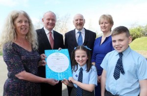 Deputy First Minister and Frances Bestley, programme director, UNICEF, presenting the Level 2 Rights Respecting School status award to pupils Rianne Doherty and Jude Power. Included are David McGimpsey, UNICEF, and Mrs. Jactina Bradley, principal. Photo: Lorcan Doherty Photography 