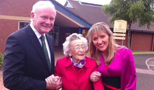 99-year-old Ita Crossan is greeted by Deputy First Minister Martin McGuinness and Sinn Fein MEP Martina Anderson on her arrival at the polling station at St John's Primary School.