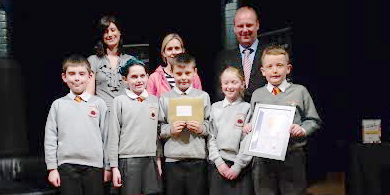 Pupils from Fountain Primary School receive the Young Enterprise NI Our City competition North West award from Eircom volunteer judges Mark Nixon and Kirsty Singleton.