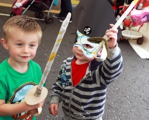 Charlie Magee, from Derry and Conor Leonard, from Belfast, show off the pirate items they made in the Arts and Crafts tent on the quay. 