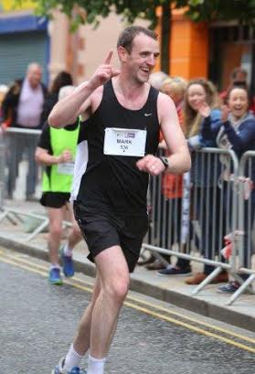 Environment Minister Mark H Durkan acknowledges the encouragement from the spectators.