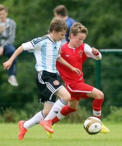 Under-12 action - Maiden City Academy's Josh Kee in a battle for possession with  Hearts' Joseph Evendon. Photo Lorcan Doherty Photography 