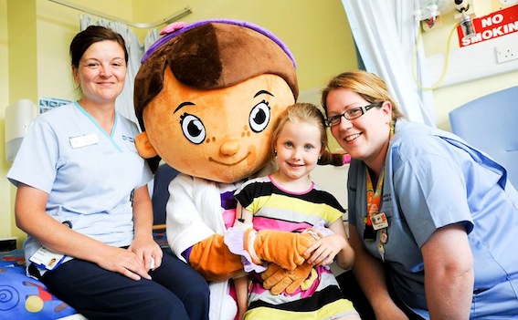Courtney Devine with Cathy Grady, Play Specialist and Catherine Lynch, Staff Nurse, having fun with Doc McStuffin from the Mighty Mascots.