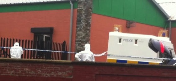Police forensic officers at the scene of the arson attack  SInn Fein's headquarters on Eastway.