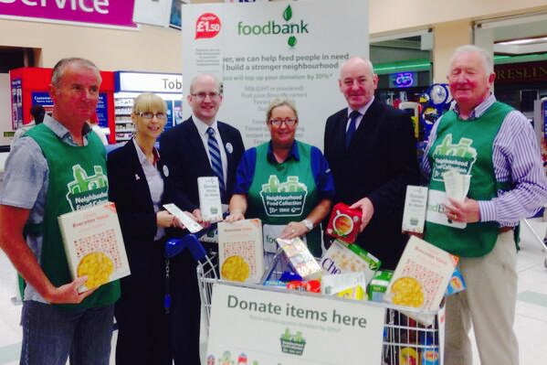 Foyle MP Mark Durkan taking part in the Tesco Foodbank collection earlier this month.