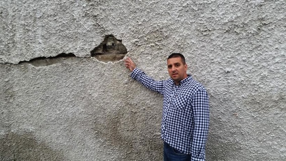 Cllr Jackson at the Distillery Court wall which he fears could collapse "at any minute."