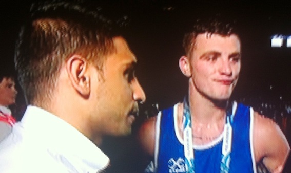 Imir Khan commiserates with Connor after his semi-final defeat at Glasgow 2014.