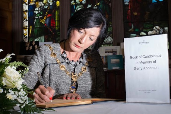 Mayor of Derry Cllr Brenda Stevenson signing the book of condolence in memory of Gerry Anderson which has been opened in the city's Guildhall.