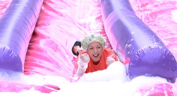 Mayor Brenda Stevenson makes a splash at the bottom of the slide on Shipquay Street.