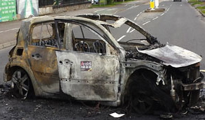 The burned out car of the Shantallow family who have been forced to leave their home due to anti-social behaviour in the area.