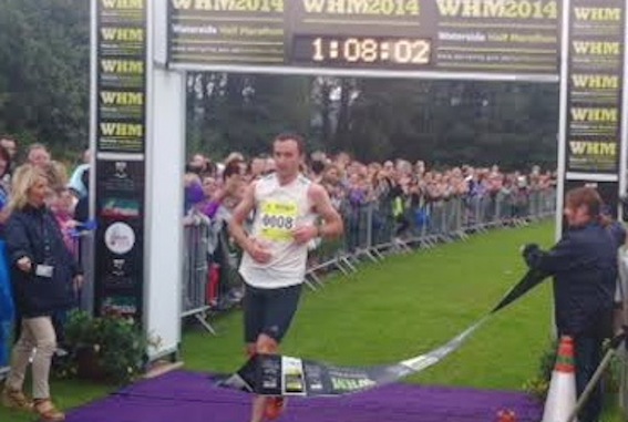 Gary Murray crosses the finish line to win today's Waterside Half Marathon.