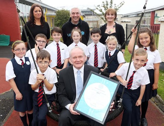 Deputy First Minister Martin McGuinness pictured with Mrs. Aine O'Connor, teacher, Paul Clarke, UNICEF Ambassador, Miss Orla McDonnell, Principal, and pupils from Holy Child Primary School, Derry, who today received the UNICEF Level 2 Rights Respecting School Award. Photo: Lorcan Doherty Photography 