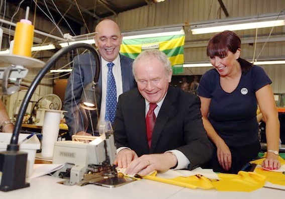 Martin McGuinness stitching a Donegal jersey together, under the supervision of Kieran Kennedy, managing director, and staff member Josie  Friel,from Lifford, during his visit to O'Neill's in Strabane. Photo: Lorcan Doherty Photography