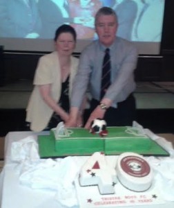 Rosie Fleming and Jim Clifford, sister and brother of Ugg, cutting the cake at the 40th anniversary dinner dance of Tristar FC.