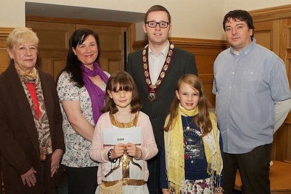 Deputy Mayor Gary Middleton with Local Democracy Week art competition winner Eisa Morgan (Model PS). Included are parents, sister Dara and granny Kathleen. Also included is Shaun McLaughlin, principal, Rosemount PS. (Photo - Tom Heaney, nwpresspics)
