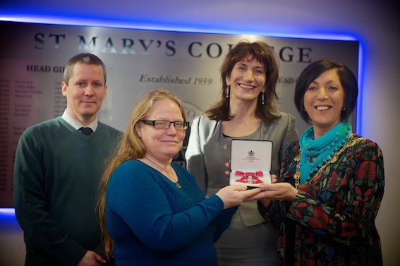 Mayor of Derry, Councillor Brenda Stevenson, with Ann Blanking, pictured with pupils and staff from St Mary's College, after collecting her MBE for services to education and the community in Northern Ireland. Included are Mark Logue and Marie Lindsay, principal.