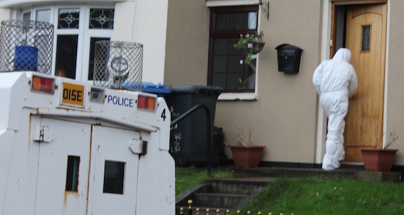 A police forensic officer entering the home of Eamon Bradley.