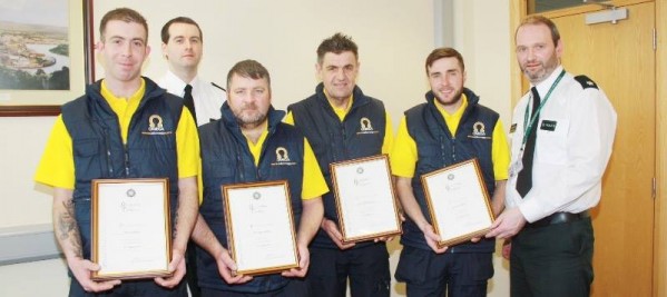 Making a presentation of recognition certificates to Omega workers are Supt Mark McEwan, right, and Constable Graeme Reynolds.