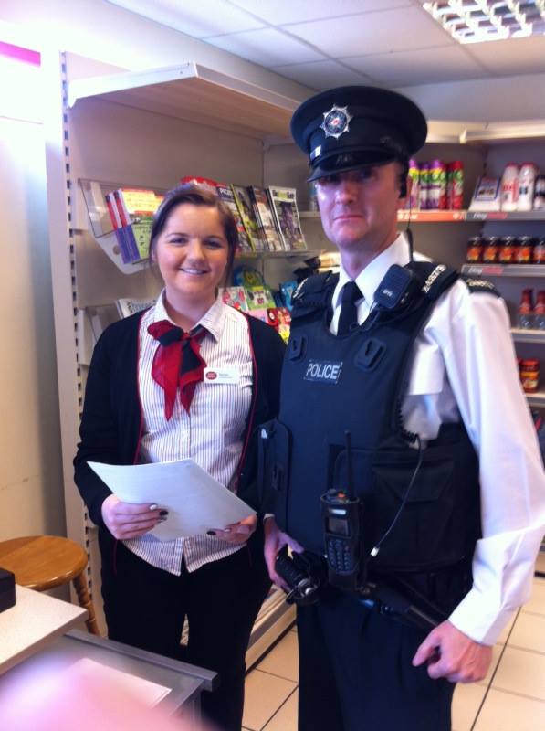 A member of staff at Tullyhogue Post Office gets some crime prevention advice from a local PSNI officer
