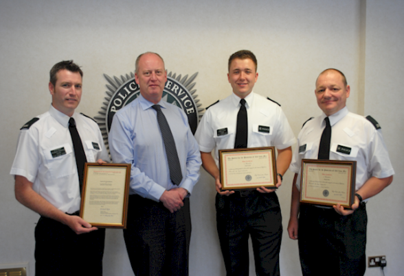 The Chief Constable George Hamilton presents certificates to L to R  Constable Richard Sharkey, Constable Dean Lovell and Constable Ade Foster.