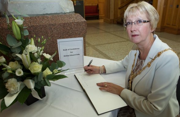 Mayor Hilary McClintock sigsn the book of condolence to the late Bishop of Derry Edward Daly