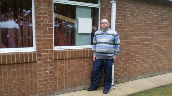 Keith Wright, Family History Centre Director at Derrys Mormon Church, pictured beside one of the broken windows.