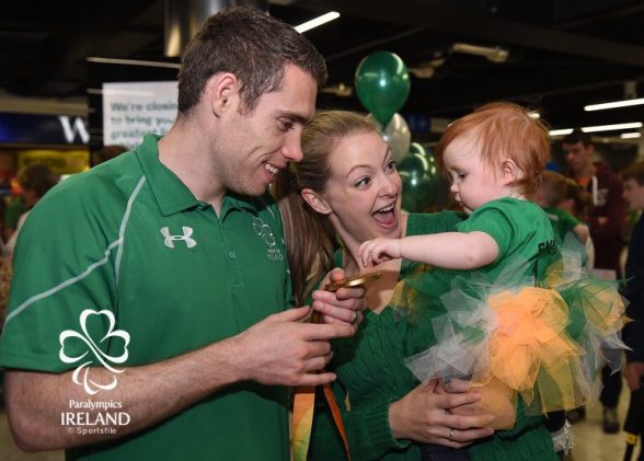 GOLDEN BOY...Derry's Jason Smyth greeted in Dublin by his proud wife and child at homecoming in Dublin airport for Ireland's Paralympians