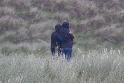 Heartbroken Family comfort each other as they look out at the sea in the hope that the body of Antony Griffiths is recovered. (North West Newspix)