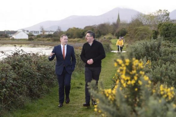 Infrastructure Minister Chris Hazzard and Jonathan Hobbs from NI Greenways enjoy a walk along an old railway track 