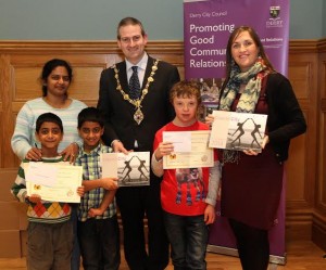 Mayor Martin Reilly, with Angela Askin (right), Derry City Council community relations officer, with winners in the youth category of Derry City Council’s  "Spice of Life" Diverse City calendar photographic competition.  From left, Shivaranjani Tetali with her son's Aarush and Aayush (3rd place) and Robert Moore, (2nd place).  Missing is Vincent McMonagle, winner. 