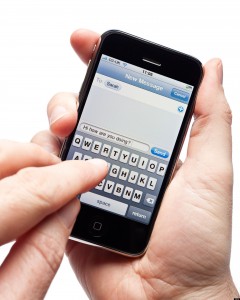Male hands using iPhone writing a text message