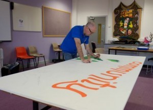 Strabane artist Noel Boyle with will with young people and local residents on the project.