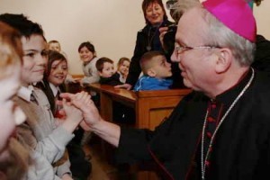 Newly appointed Bishop of  Derry Donal McKeown is greeted by young St Eugene's PS pupil Callum Friar.  (NWNewspix)