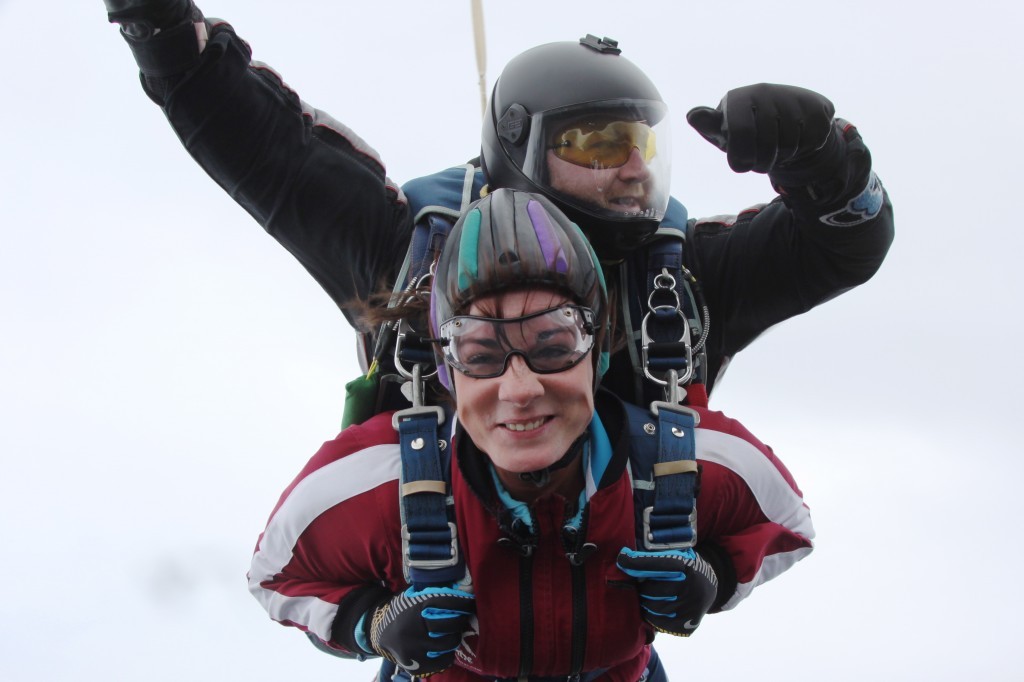 Ceilidh smiles for the camera during her skydive tandem instructor Rod McCrory.