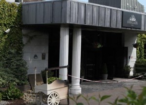 The damaged entrance to the Everglades Hotel following this morning's firebomb attack.