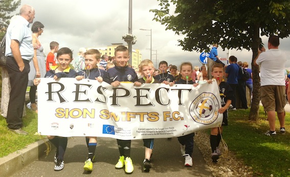 The Sion Swifts team carrying the "Respect" banner during the parade.