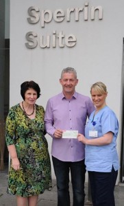 Seamus Doherty presenting a cheque for £1,000, the proceeds of his London Marathon run, to Sperrin Suite staff, Liz England, Cancer Services Manager and Staff Nurse Aisling McGarvey.