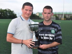 Sinn Fein Cllr Colly Kelly presenting Brendy McDonald, captain of last year's winning team Creggan.