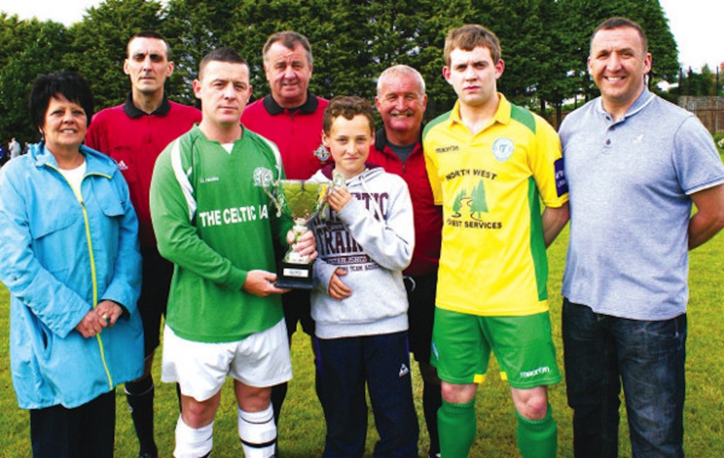 John Barry Quigley presents the 2013 Tony Quigley/Shakes McDowell Memorial Cup to TJ Anderson, captain of Celtic Swifts. Included Francesca McDowell, match officials Mark McGarrigle, Noel Moore and Martin Dunne, Hugh Carlin, captain Finn Harps (defeated finalists) and Stephen Quigley.
