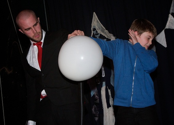 A young boy assists the "Bruce Airhead"