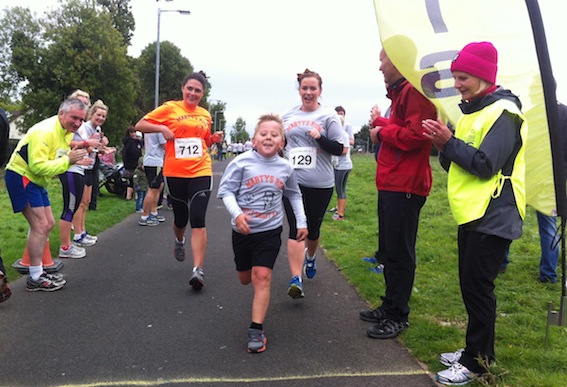 Shea Sharkey, of St Anne's Primary School, crossing the line to finish Marty's Run.