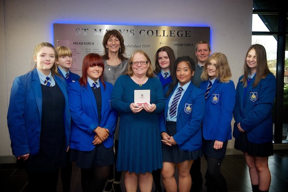 Anne Blanking with pupils and staff from St Mary's College after collecting her MBE for services to education and the community in Northern Ireland. Included, are Erin McPhilemy, Justine Munoz, Aoife Nash, Nicole McHugh, Megan Doherty, Aoife Bolster, Lavina Blanking, Mr Mark Logue and Marie Lindsay, principal.