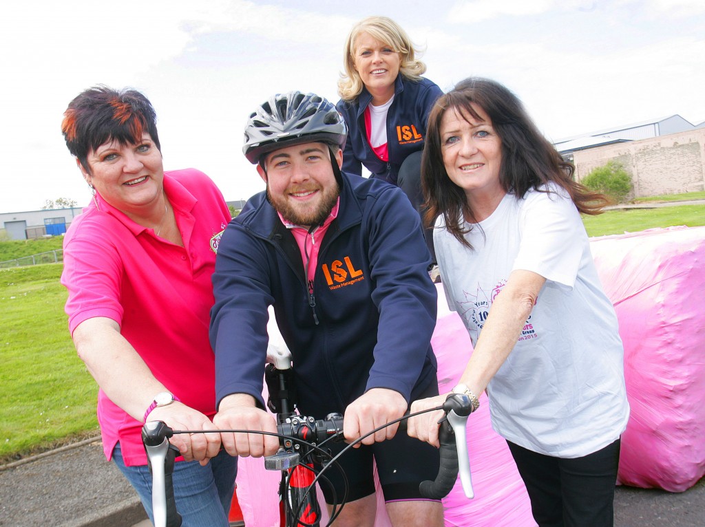 Barry Donaghy, Managing Director of ISL Waste Management, is pictured with (l-r) Joanne Young, Macmillan Cancer Support, Beverley Caldwell (standing) and Eileen Curran, from The Pink Ladies Cancer Support Group, and the pink wrapped bales that will mark milestones on a fundraising journey to raise a target donation of £10,000.