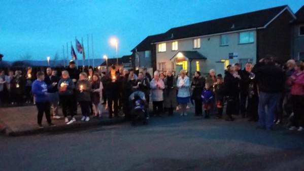 Caw Nelson Drive residents with lit candles remember the victims of Buncrana pier tragedy and those murdered in Brussels