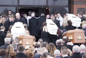 the remains of the five tragic family members are carried into the Holy Famoily Church for Funeral service.  (North West Newspix)