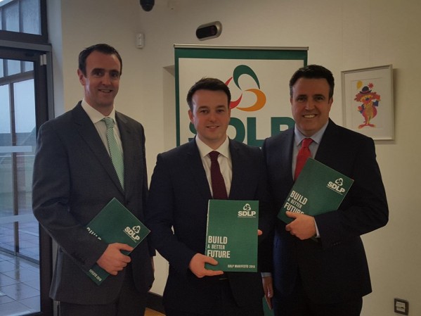 Colum Eastwood with Foyle candidates Mark H Durkan (left) and Gerry Diver with the party's 2016 manifesto